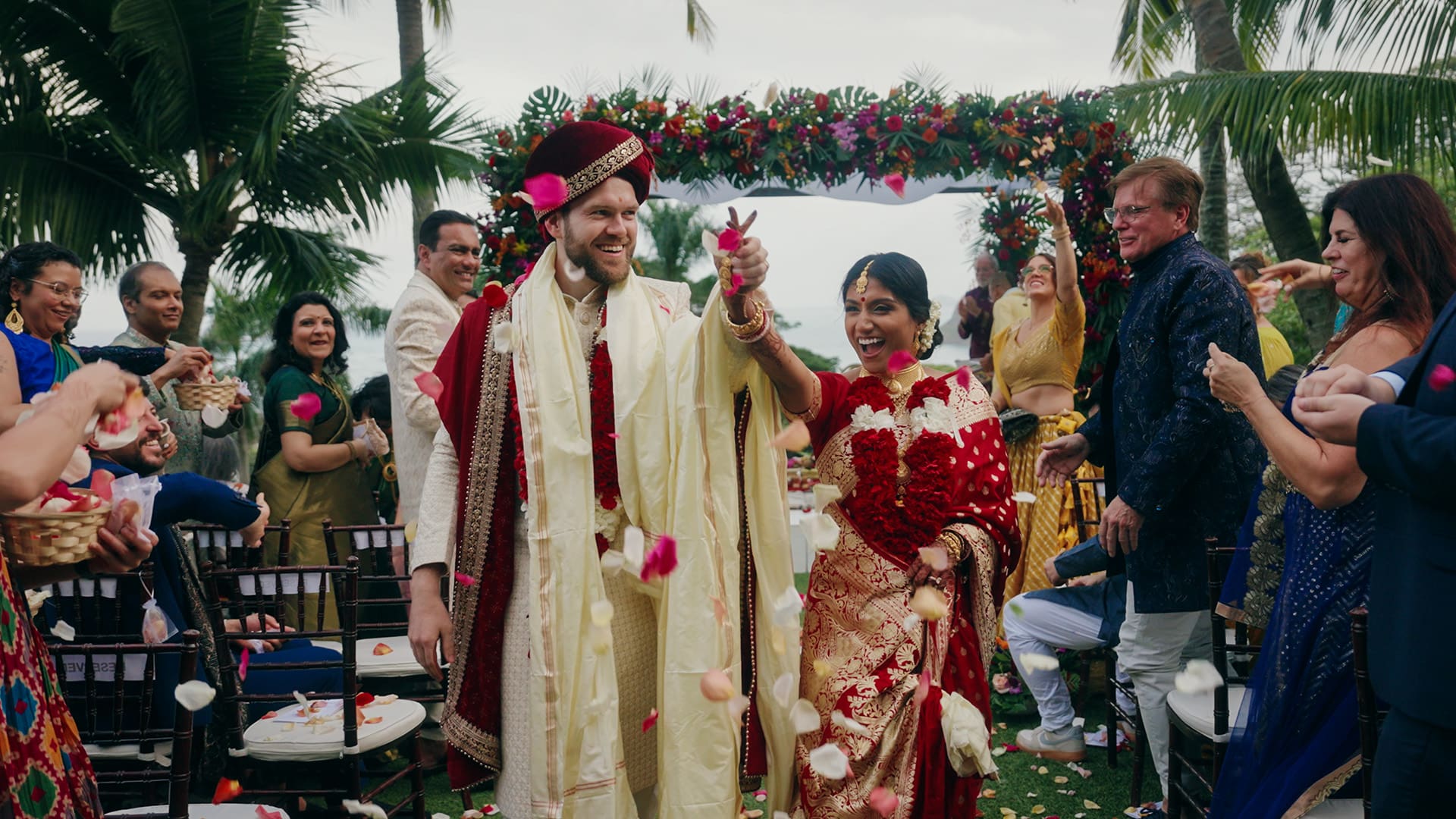 Indian Wedding at Paliku Gardens: Nivedita and Nick celebrating with flowers