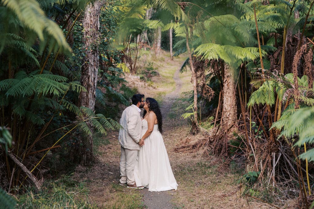 Couple kissing on a trail at Hawai'i Volcanoes National Park, Big Island Hawaii
