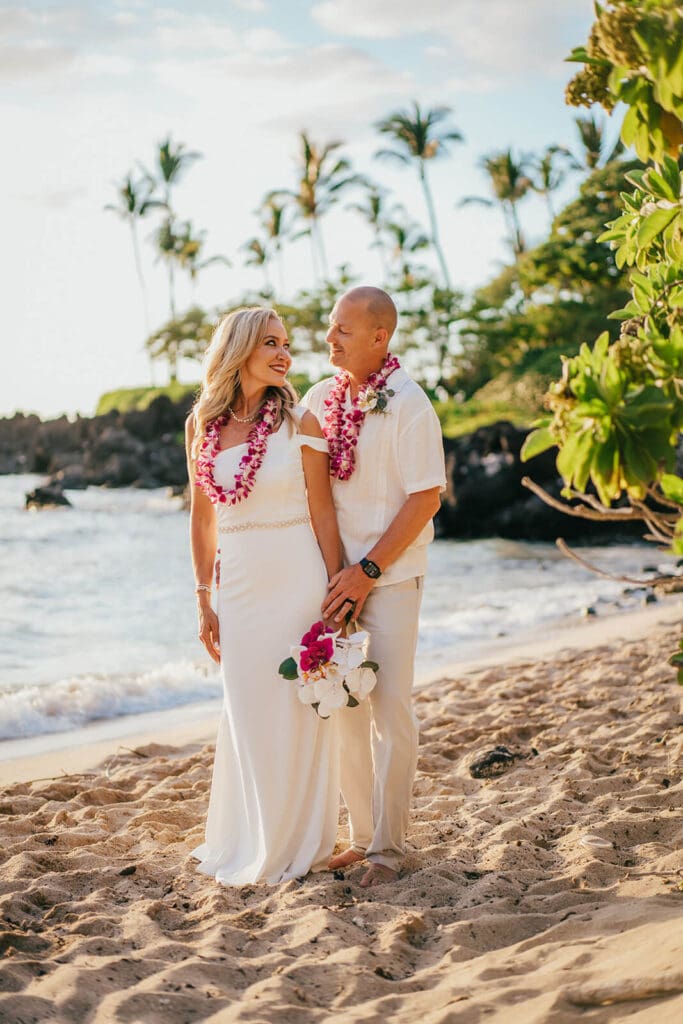 Couple walking on the beach at Kukio Beach, Kona Hawaii wedding photography