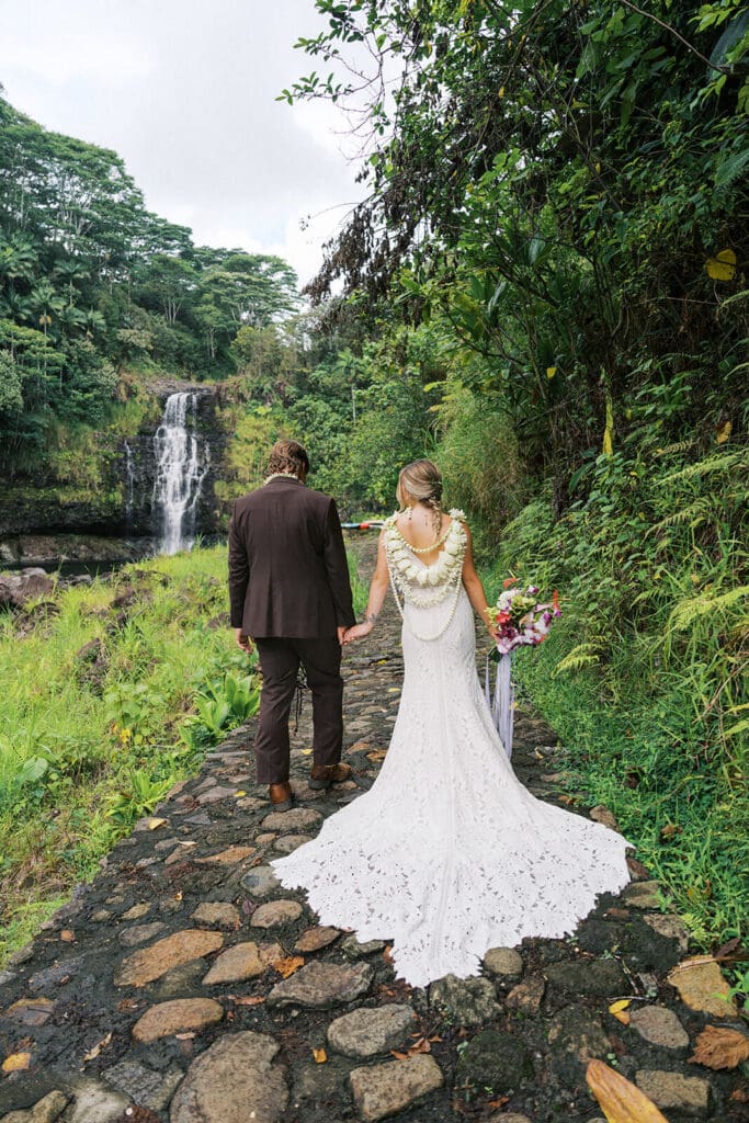Couple walking on a trail toward Kulaniapia Falls, Big Island Hawaii wedding photos