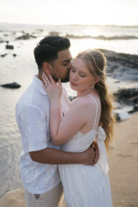Couple embracing on white beach at Old Kona Airport Beach