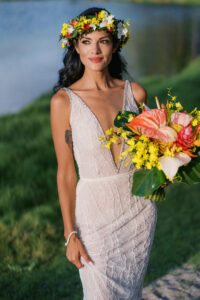 Bride standing on the beach by the reflective pond at A-Bay in Waikoloa