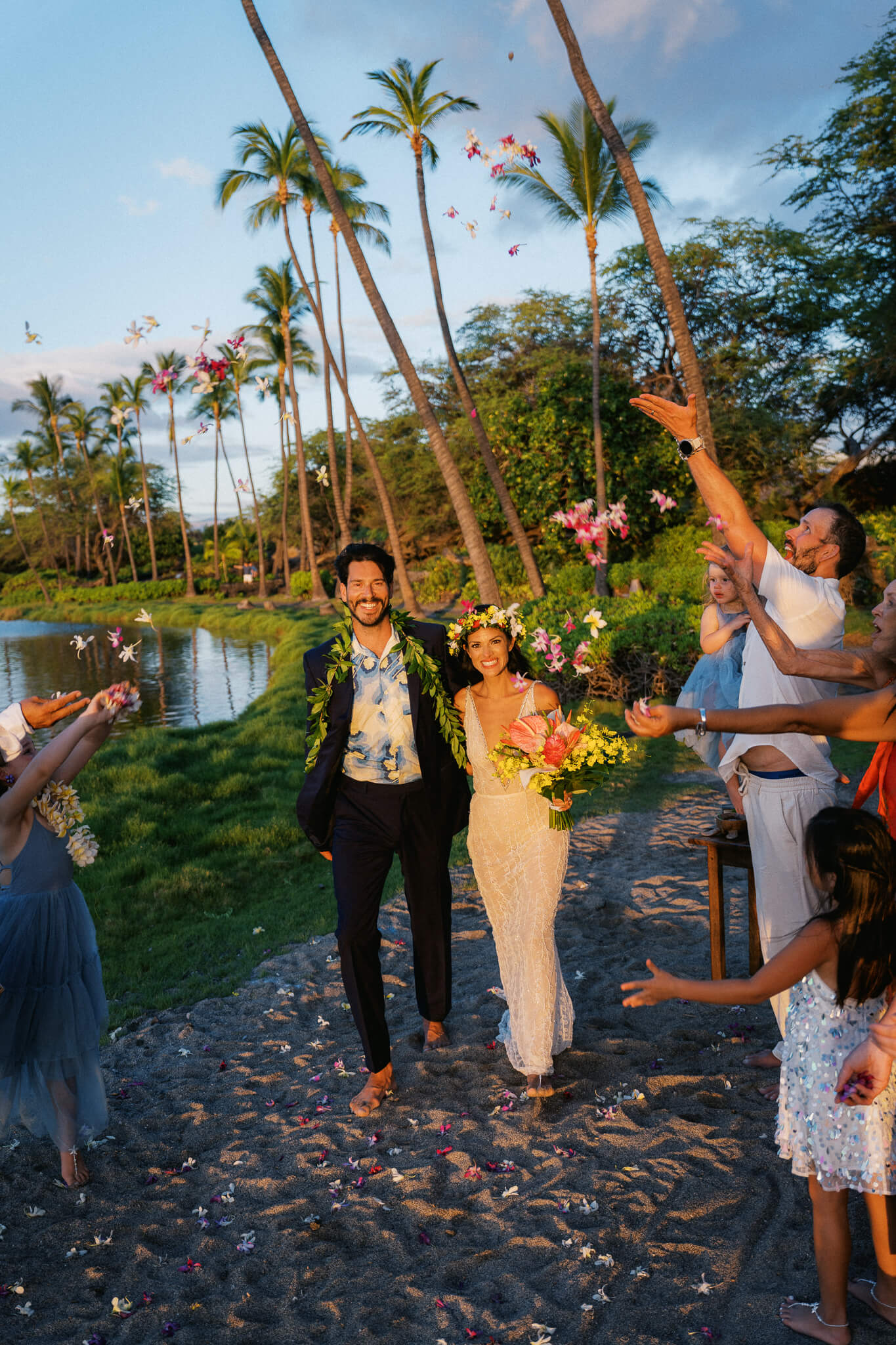 Newlyweds celebrating with flowers tossed in the air at A-Bay