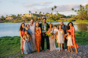 Family posing together for a photo at an A-Bay beach wedding